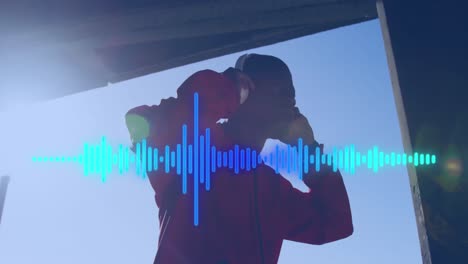 Animation-of-soundwaves-over-african-american-man-in-headphones-exercising-outdoors-in-sun