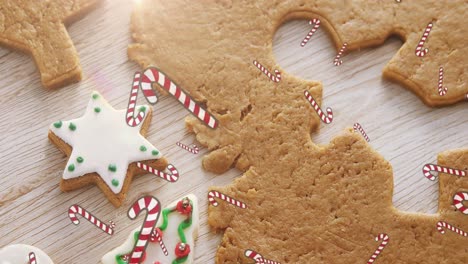 Animation-of-christmas-candies-over-cookies-dough-and-mold