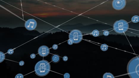 Animation-of-network-of-connections-with-icons-over-landscape-at-sunset