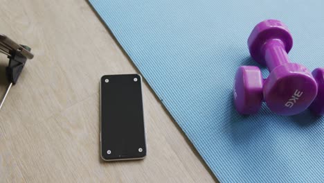 Video-of-weights,-mat-and-smartphone-lying-on-floor