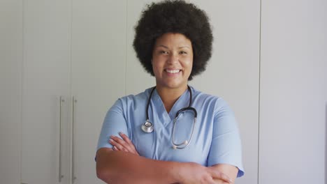 Video-of-happy-plus-size-african-american-female-doctor-looking-at-camera