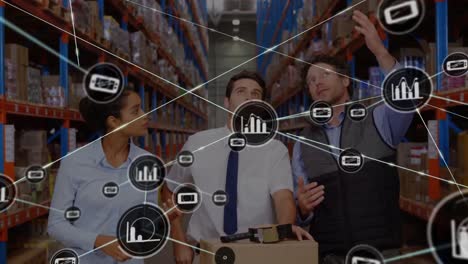 Animation-of-network-of-connected-business-icons-over-three-diverse-workers-in-warehouse