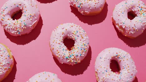 Video-Von-Donuts-Mit-Zuckerguss-Auf-Rosa-Hintergrund