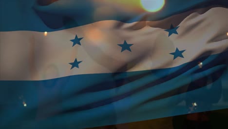 Animation-of-waving-of-honduras-flag-over-group-of-friends-on-the-beach
