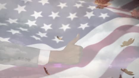 Animation-of-hand-with-thumb-up-and-leaves-over-flag-of-usa