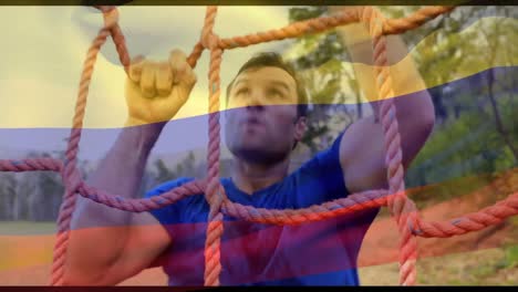 Animation-of-flag-of-columbia-over-caucasian-man-during-obstacle-race-training