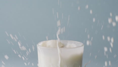 Video-of-glass-of-milk-with-copy-space-on-blue-background