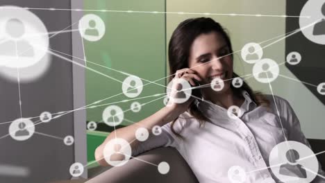 Animation-of-network-of-connections-over-happy-caucasian-woman-using-smartphone