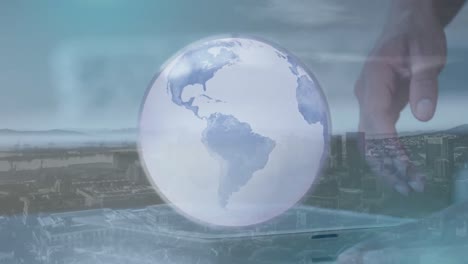 Animation-of-globe-and-cityscape-over-caucasian-businessman-using-tablet
