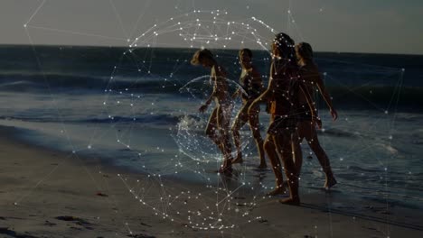 Animation-of-globe-and-connections-over-diverse-female-friends-walking-on-beach-at-sunset