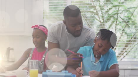 Animation-of-bokeh-over-happy-african-american-father-and-children-in-kitchen
