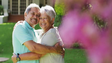 Video-of-happy-biracial-senior-couple-embracing-in-garden