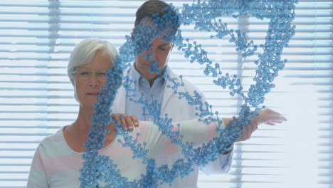 Animation-of-dna-strand-over-caucasian-male-doctor-treating-senior-female-patient