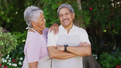 Video-of-happy-biracial-senior-couple-laughing-in-garden