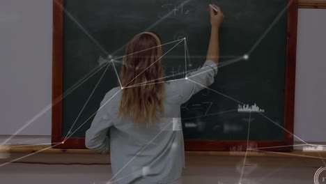 Animation-of-network-of-connections-over-caucasian-female-teacher-writing-on-board
