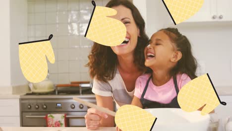Animation-of-kitchen-gloves-over-happy-caucasian-mother-and-daughter-cooking-together