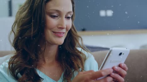 Animation-of-snow-falling-over-happy-caucasian-woman-using-smartphone
