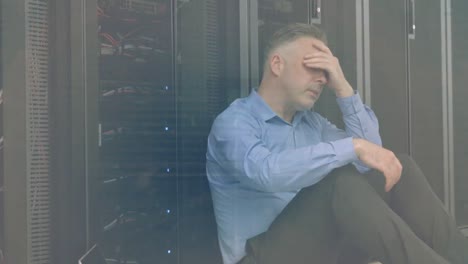 Animation-of-data-processing-over-tired-caucasian-male-it-technician-and-computer-servers