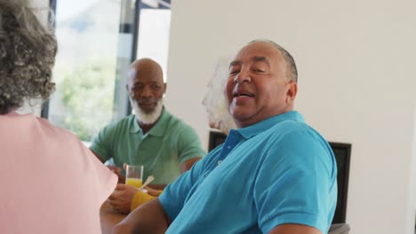 Portrait-of-happy-senior-diverse-people-having-breakfast-at-retirement-home