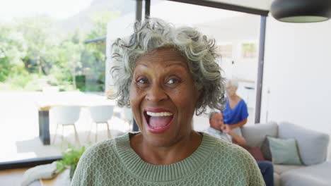 Portrait-of-happy-senior-african-american-woman-with-other-seniors-at-retirement-home
