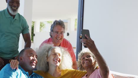 Happy-senior-diverse-people-taking-selfie-at-retirement-home
