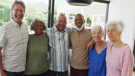 Portrait-of-happy-senior-diverse-people-embracing-at-retirement-home