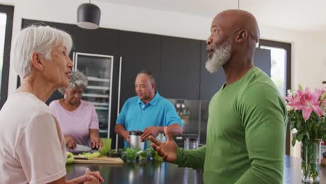 Happy-senior-diverse-people-cooking-in-kitchen-at-retirement-home