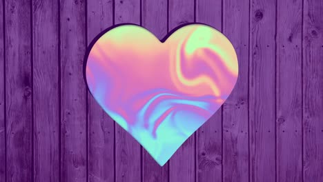 Animation-of-colorful-pastel-background-over-heart-shapes-hole-in-violet-wooden-surface