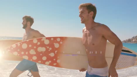 Animation-of-light-over-happy-caucasian-men-running-with-surfboards-on-beach