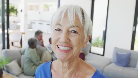 Portrait-of-happy-senior-caucasian-woman-with-other-seniors-at-retirement-home