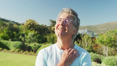 Happy-senior-caucasian-man-in-garden-on-sunny-day-at-retirement-home