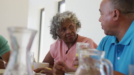 Happy-senior-diverse-people-having-breakfast-at-retirement-home