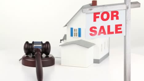 Animation-of-house-for-sale-sign-and-house-on-white-background