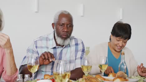 Happy-senior-diverse-people-having-dinner-at-retirement-home