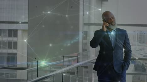 Animation-of-globe-and-connections-over-african-american-businessman-using-smartphone