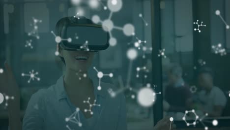 Animation-of-molecules-over-caucasian-woman-wearing-vr-headset-in-office