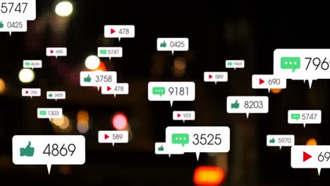 Animation-of-social-media-icons-and-numbers-over-out-of-focus-city-lights