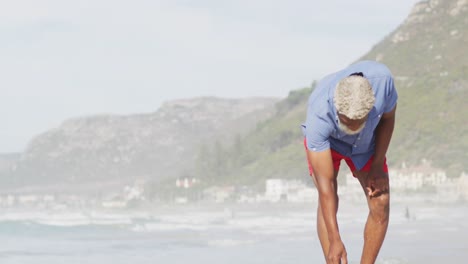 Senior-african-american-man-walking-alone-on-sunny-beach