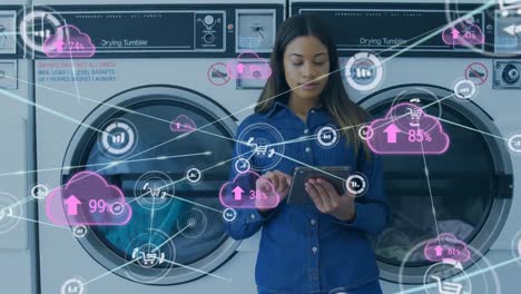 Animation-of-network-of-connections-with-clouds-over-biracial-woman-using-smartphone-at-laundry