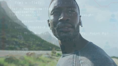 Data-processing-against-african-american-fit-man-wearing-wireless-earphones-outdoor
