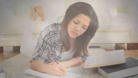 Animation-of-bokeh-over-happy-asian-woman-writing-in-notebook