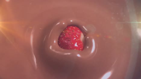 Animation-Von-Licht-über-Einer-Erdbeere,-Die-In-Geschmolzene-Milchschokolade-Fällt
