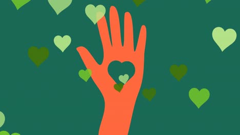 Animation-of-hearts-and-hand-over-green-background