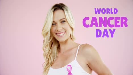 Animation-of-world-cancer-day-over-happy-caucasian-woman-on-pink-background
