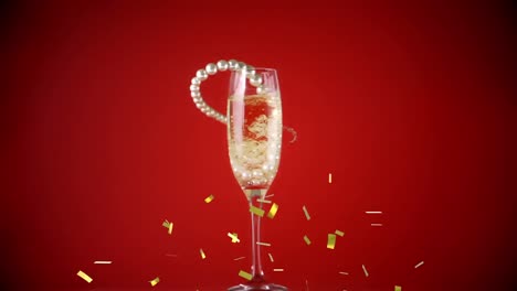 Animation-of-falling-confetti-over-glass-of-champagne-on-red-background