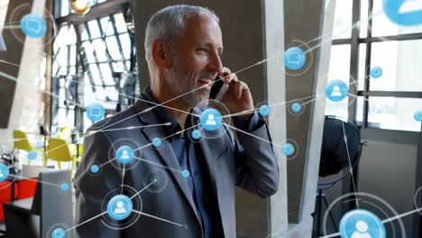 Animation-of-network-of-connections-over-caucasian-businessman-talking-on-smartphone