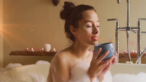 Animation-of-light-spots-over-caucasian-woman-drinking-coffee-and-taking-bath