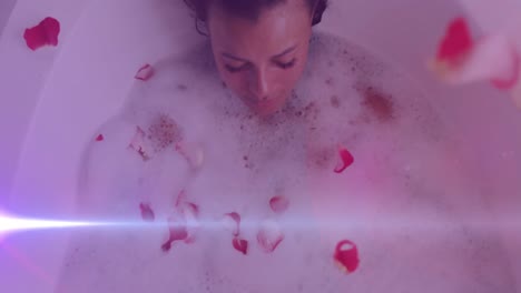 Animation-of-light-spots-over-caucasian-woman-taking-bath-with-petals