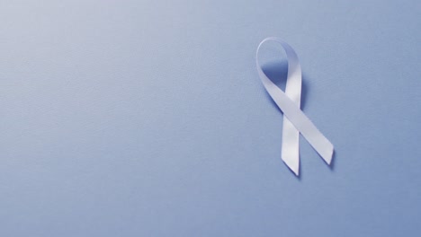 Video-of-pale-blue-prostate-cancer-ribbon-on-blue-background