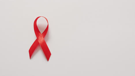 Video-of-red-blood-cancer-ribbon-on-white-background